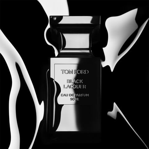 Un flacon de parfum noir élégant portant l'inscription « Tom Ford Black Lacquer Eau de Parfum 50 ml » est présenté devant un arrière-plan contrasté noir et blanc évoquant un liquide, conférant à l'ensemble une allure luxueuse et élégante.